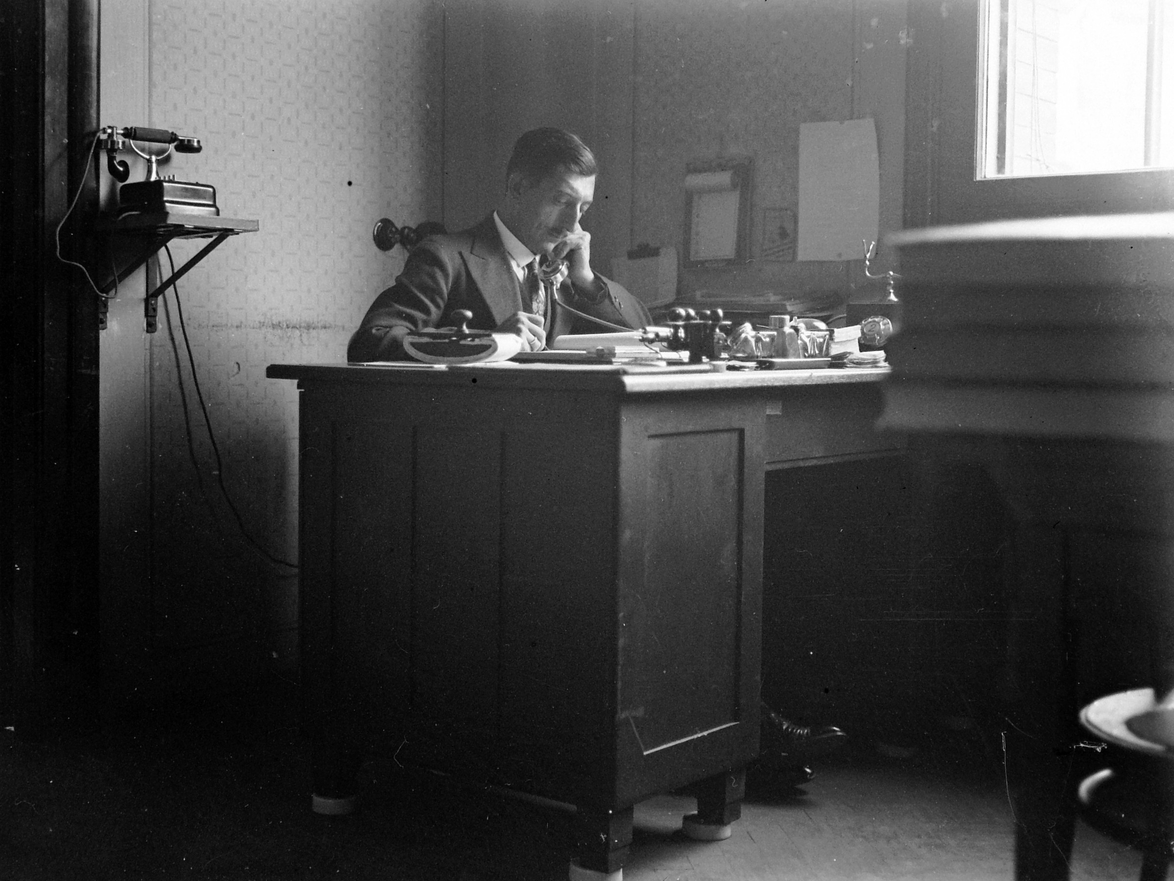Историческая рабочая сцена с отдельным столом и телефоном как метафора локальной пробы изменения.
